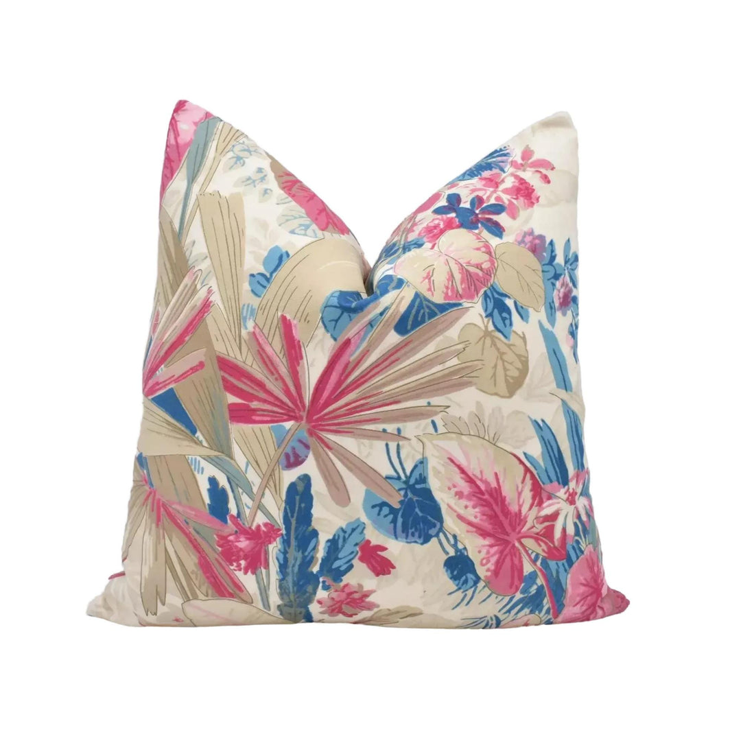 a vibrant, colorful floral print pillow with a mix of pink, blue, and green colors.