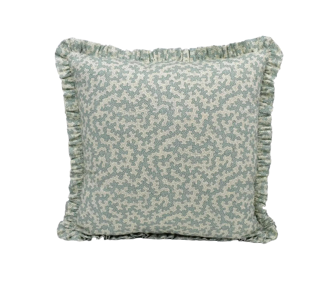 A square throw pillow with a light green floral pattern and a ruffled trim around the edges.