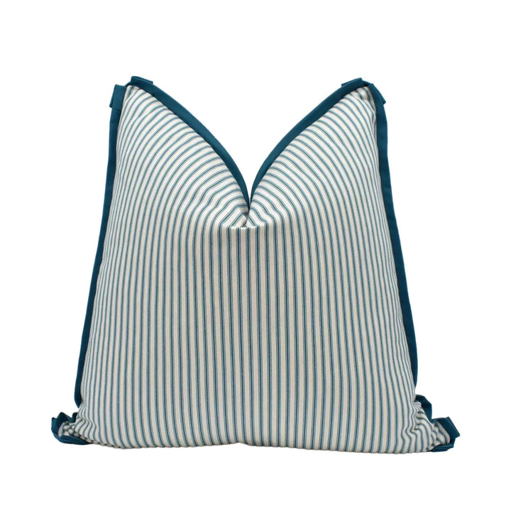 A blue and white striped pillow with a dark blue trim.