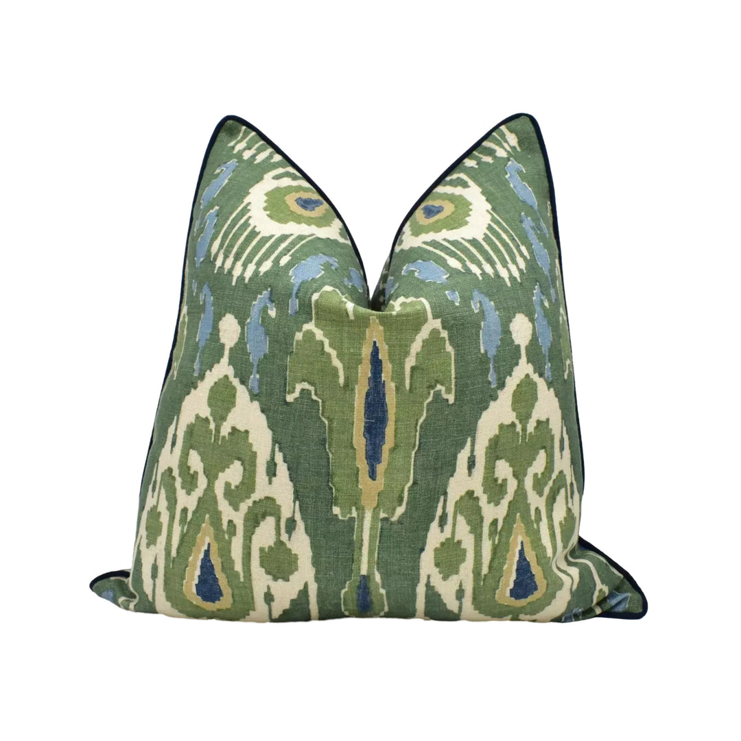 A decorative throw pillow with a green and white patterned design.