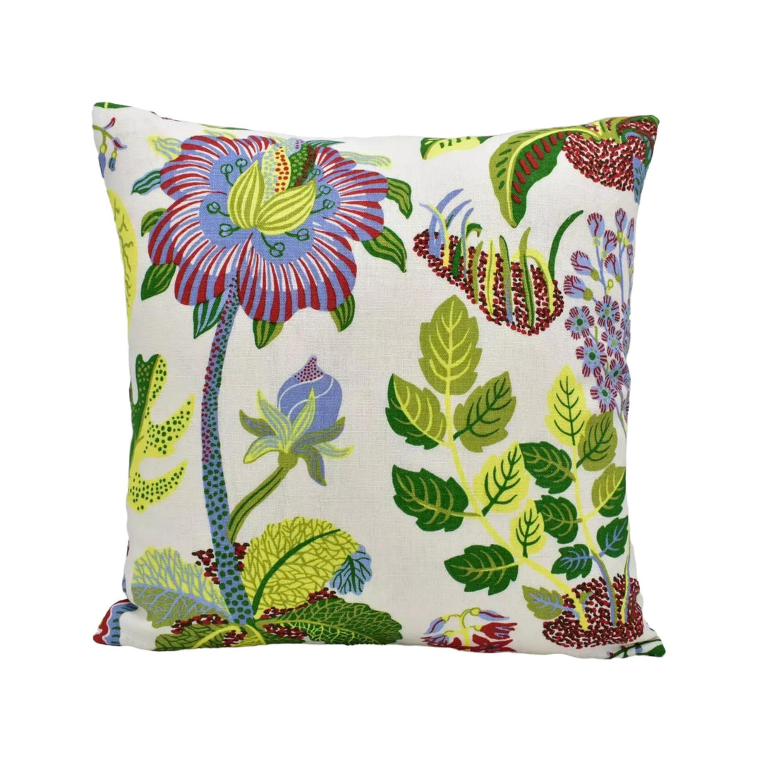 A square throw pillow with a vibrant floral and leaf pattern in various colors, including red, green, blue, and yellow.
