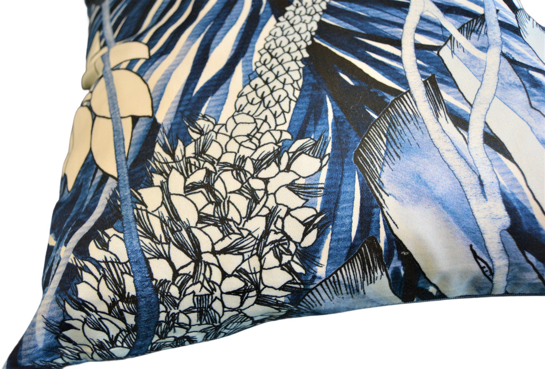 a blue and white pillow with a flower design