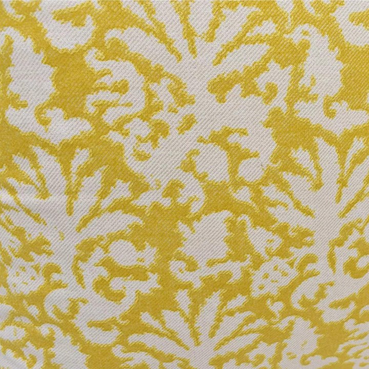 a close-up view of a fabric with a yellow and white floral pattern. The pattern consists of repeating yellow and white floral motifs, creating a visually striking and intricate design.