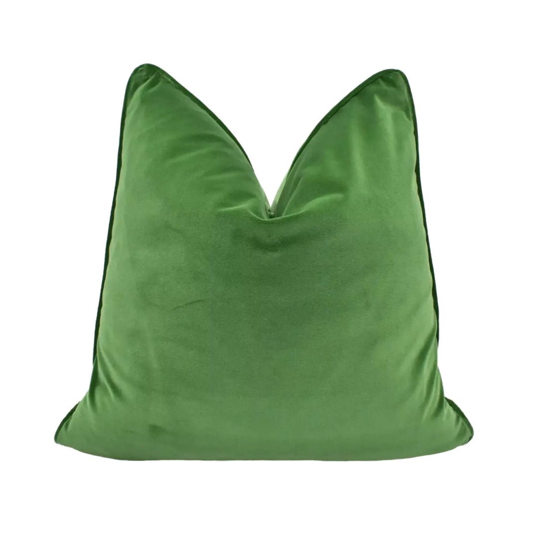 A large, green, plush pillow with a pointed top and a thin black border.