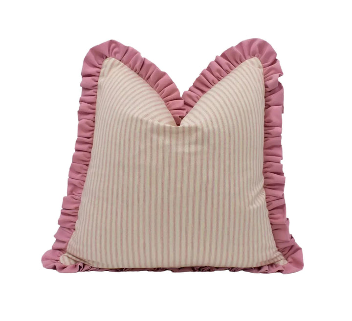 A decorative pillow with a pink and white striped pattern and a ruffled trim.