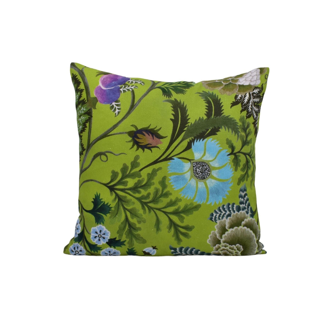 a green pillow with blue flowers on it