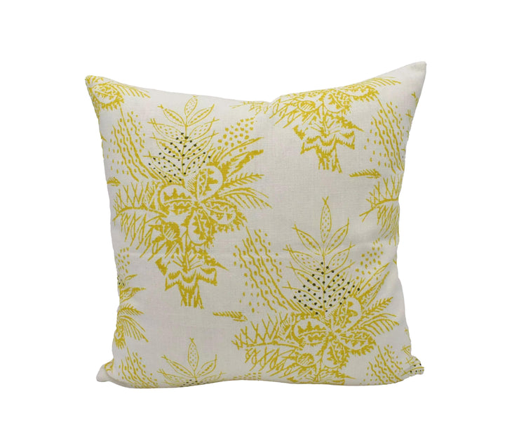 A white pillow with a yellow floral pattern.