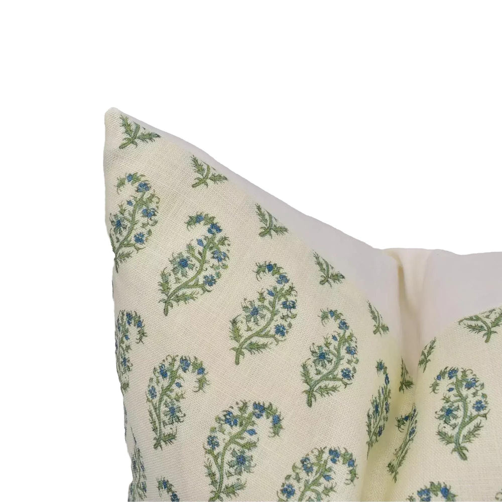 a close-up view of a decorative pillow with a floral pattern in shades of green and blue.