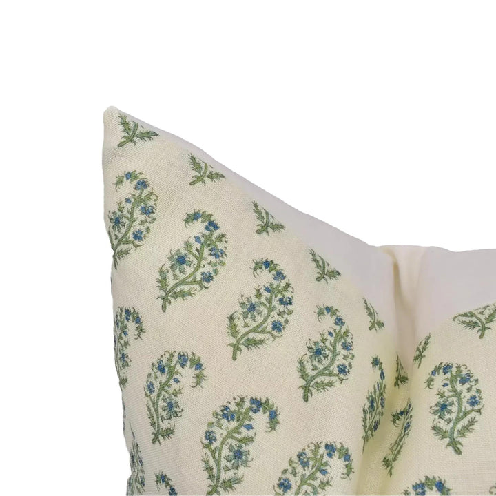 a close-up view of a decorative pillow with a floral pattern in shades of green and blue.