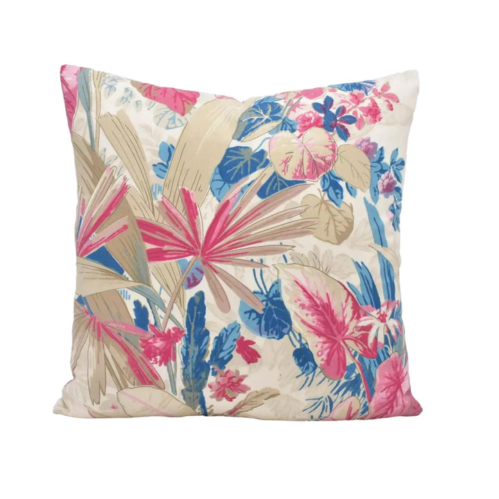A decorative throw pillow with a vibrant floral pattern in shades of pink, blue, and green.