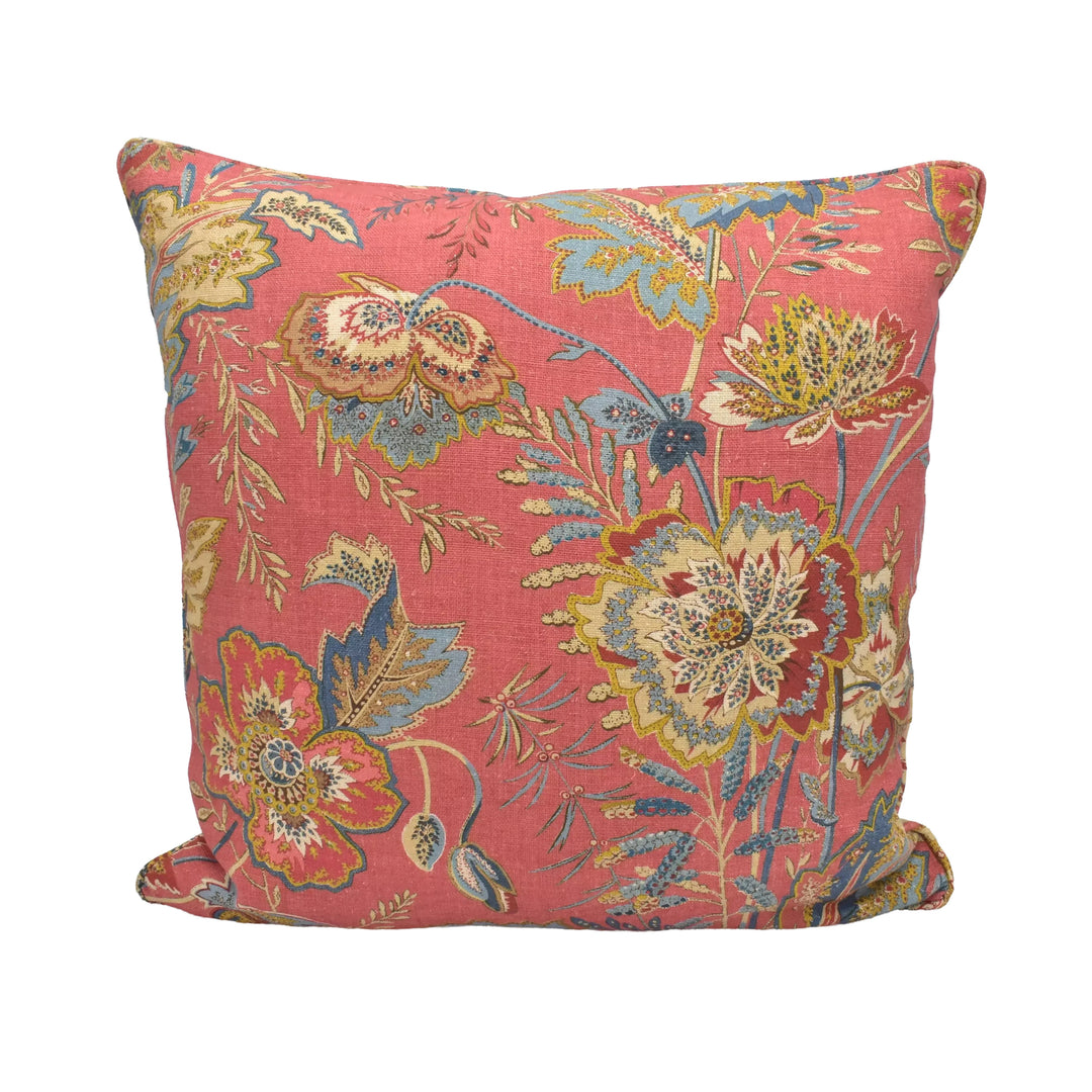 A vibrant, floral-patterned throw pillow with a mix of pink, yellow, and blue colors.