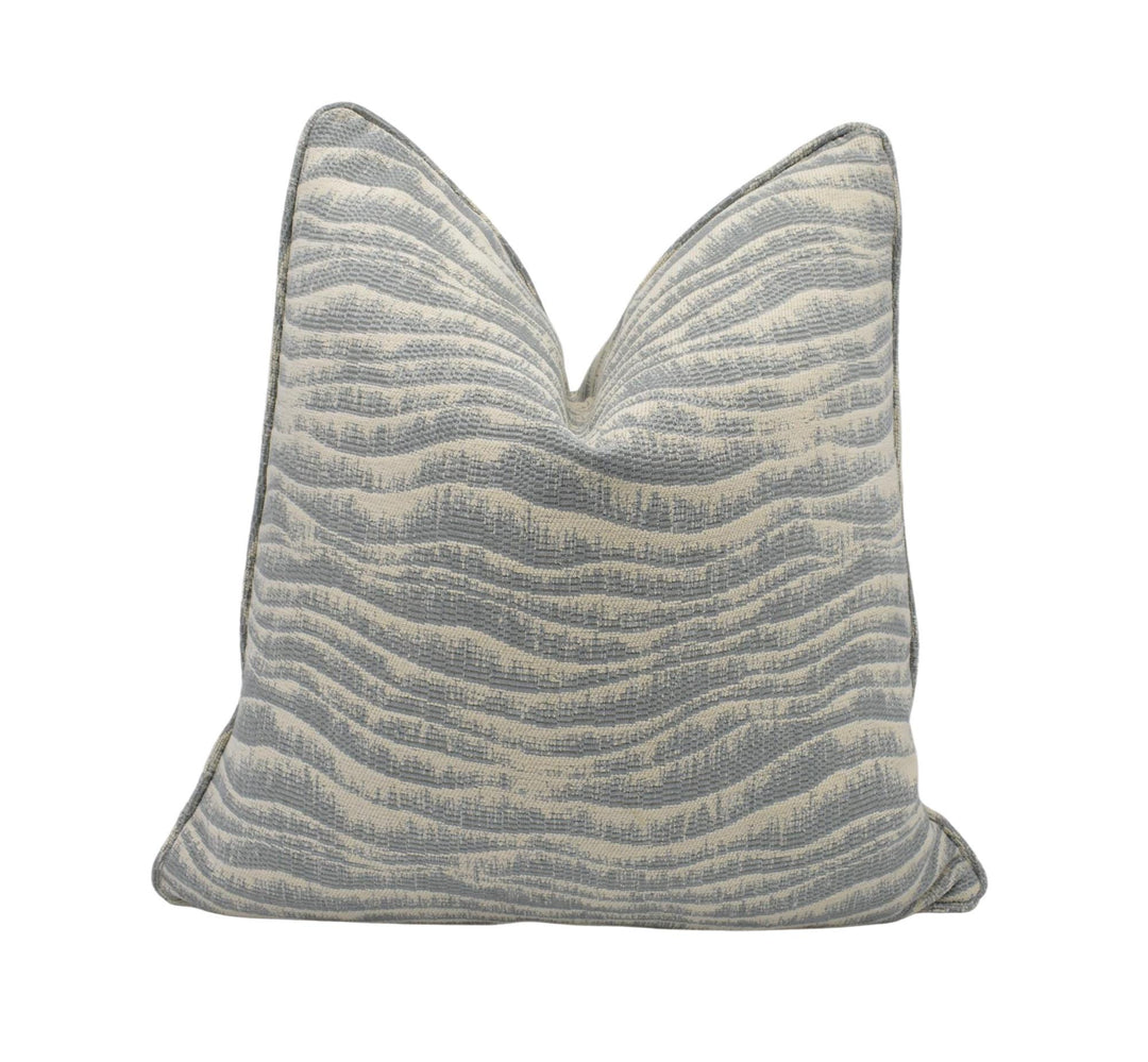 A gray and white striped throw pillow is shown against a white background.