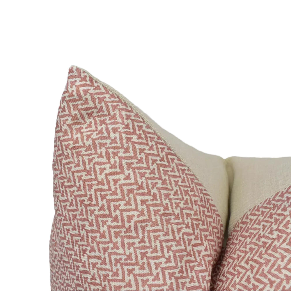 a close-up view of a decorative pillow with a red and white zigzag pattern.
