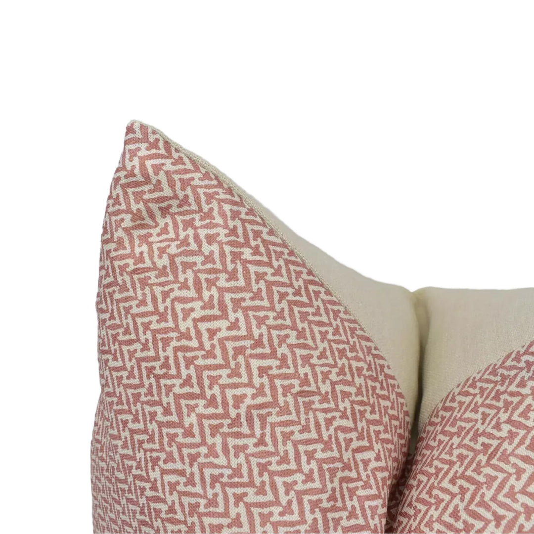 a close-up view of a decorative pillow with a red and white zigzag pattern.