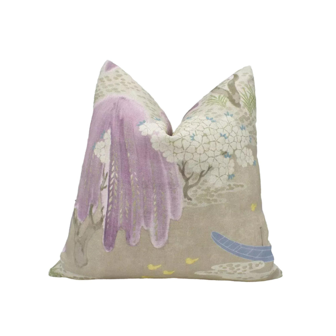 a decorative pillow with a floral pattern in shades of purple and white.