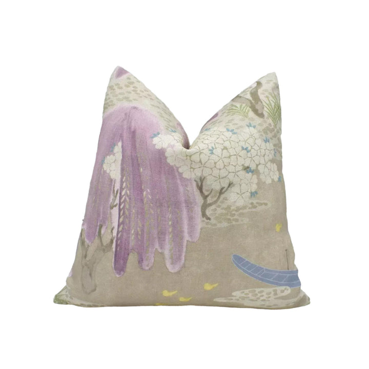 a decorative pillow with a floral pattern in shades of purple and white.