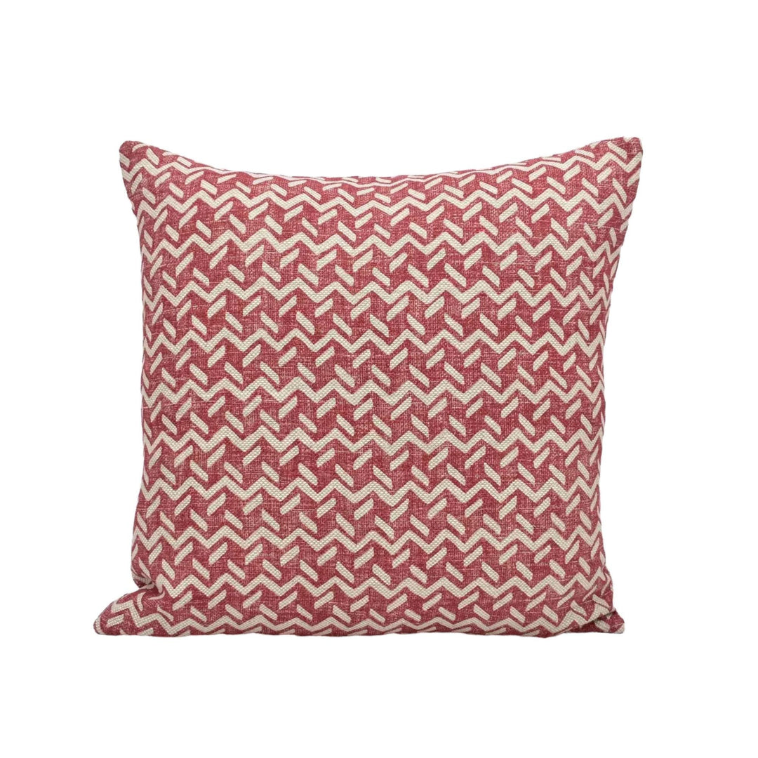 A square throw pillow with a red and white geometric pattern.