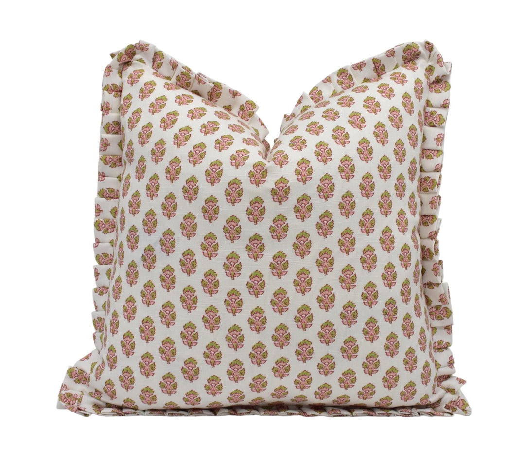 a white pillow with pink flowers on it