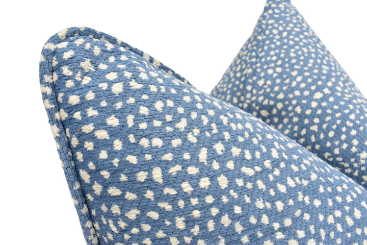 a close up of a blue and white pillow on a white background