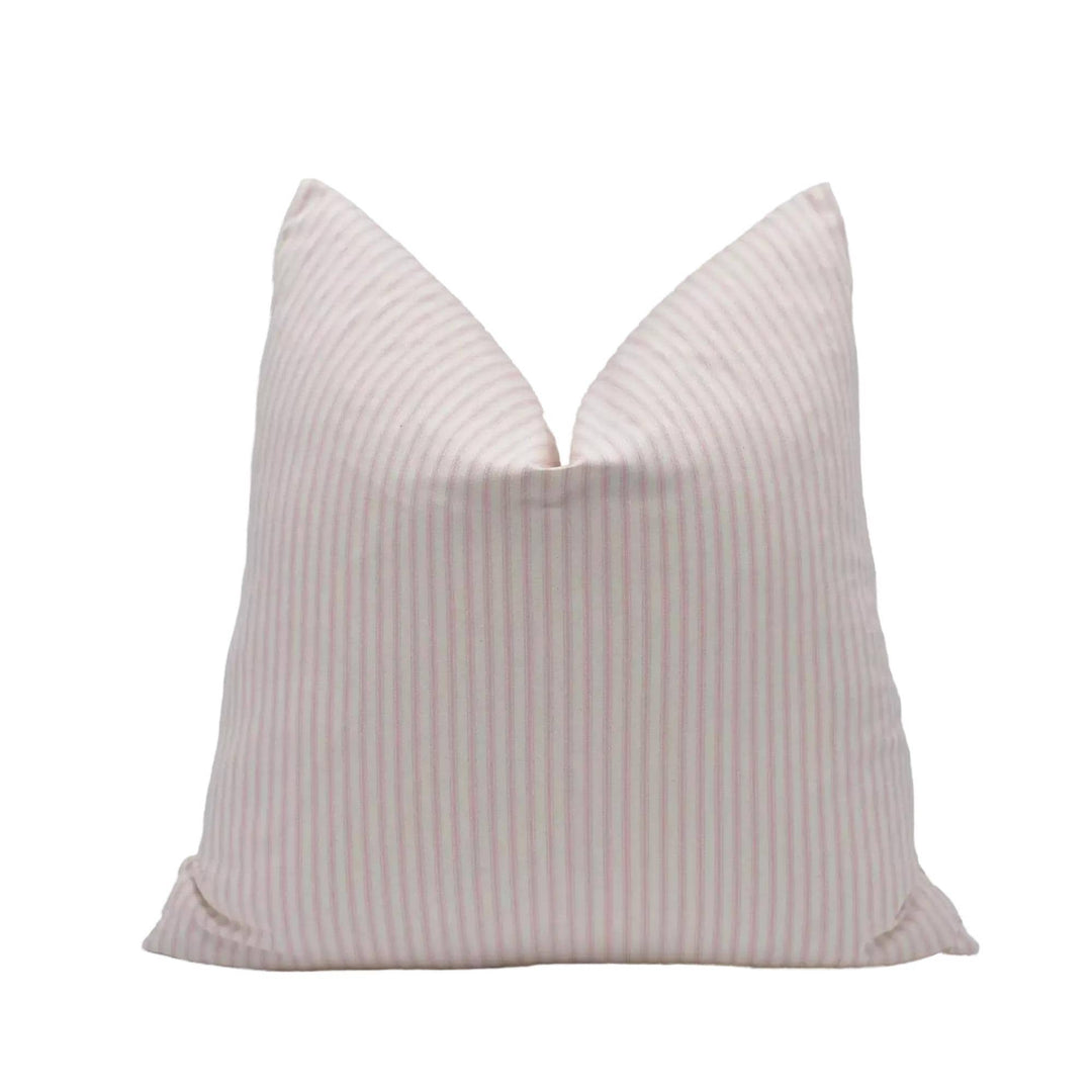 A single pillow with a striped pattern in shades of pink and white.