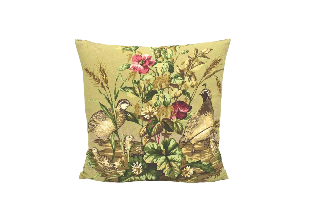 A decorative throw pillow with a vibrant floral and bird design, featuring a variety of colorful flowers and birds.