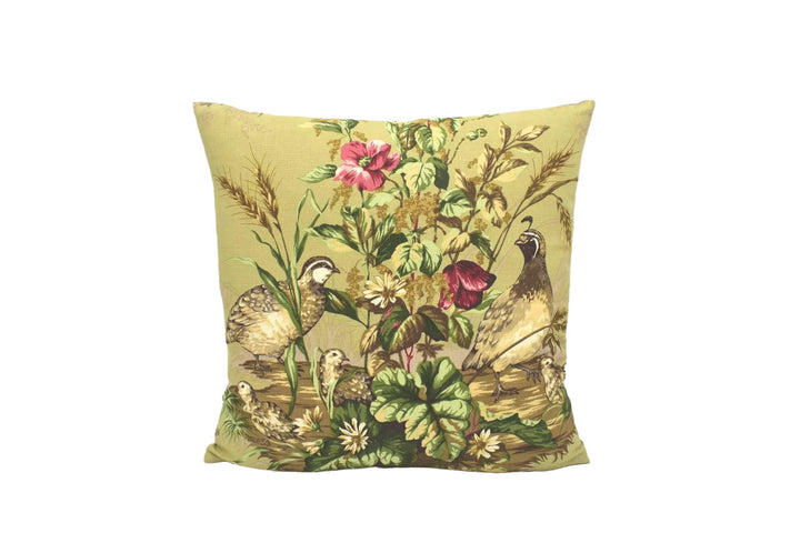A decorative throw pillow with a vibrant floral and bird design, featuring a variety of colorful flowers and birds.