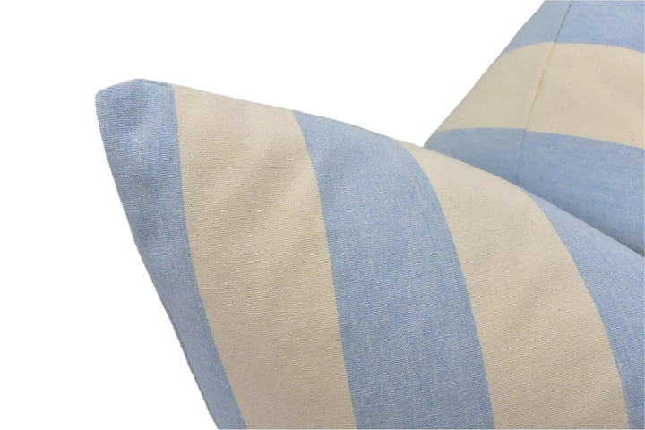 A close-up view of a blue and white striped pillow, with the fabric appearing soft and comfortable.