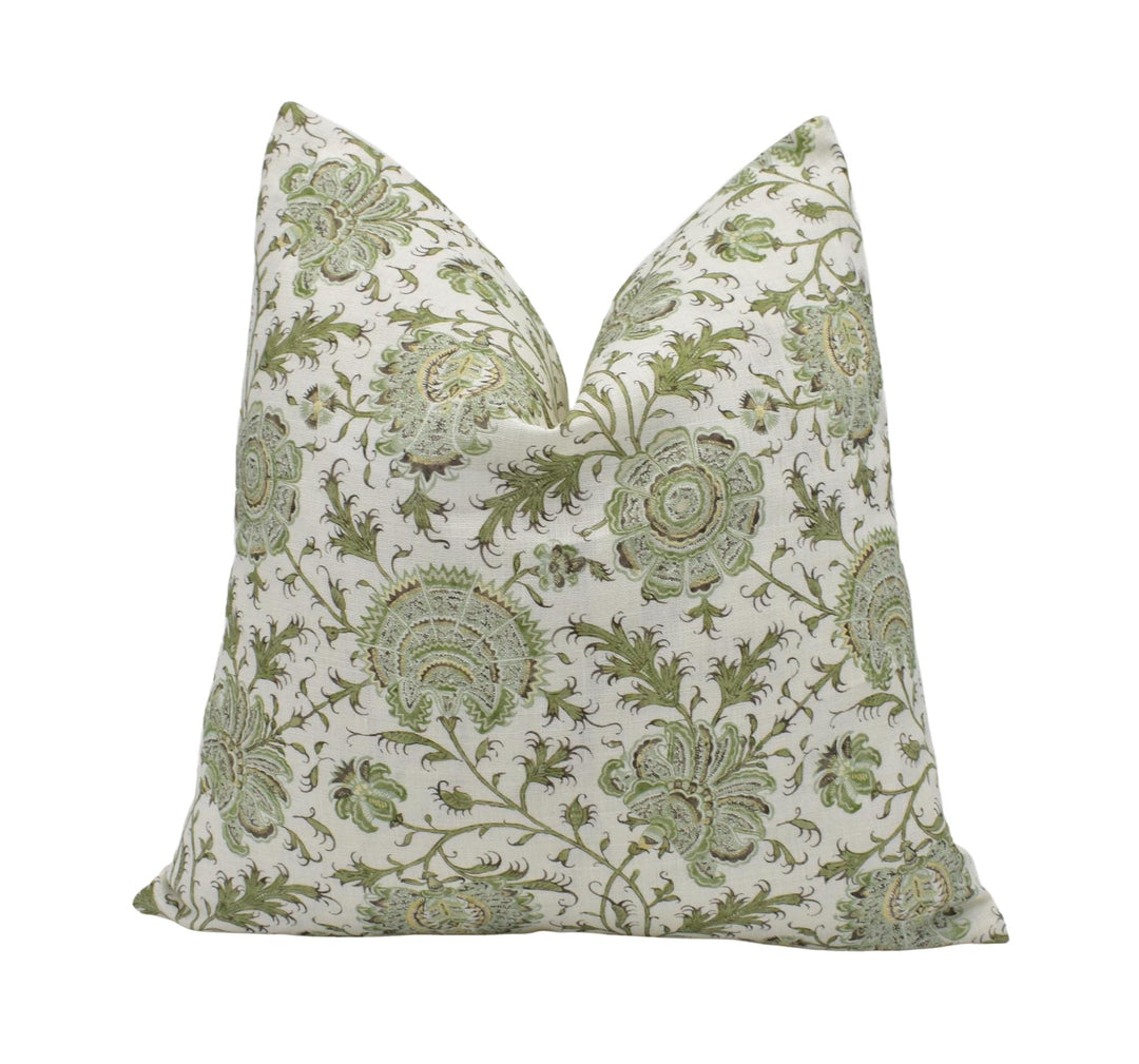 a white pillow with a green paisley pattern