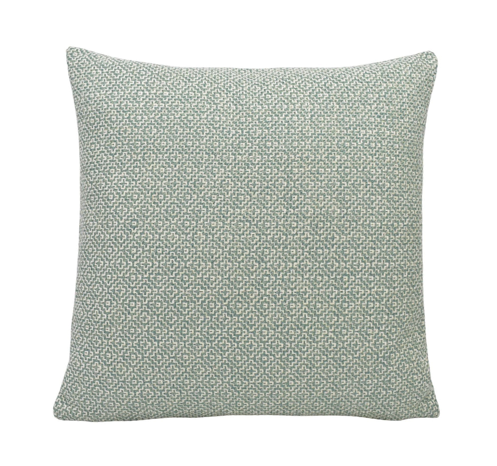 a green and white pillow on a white background