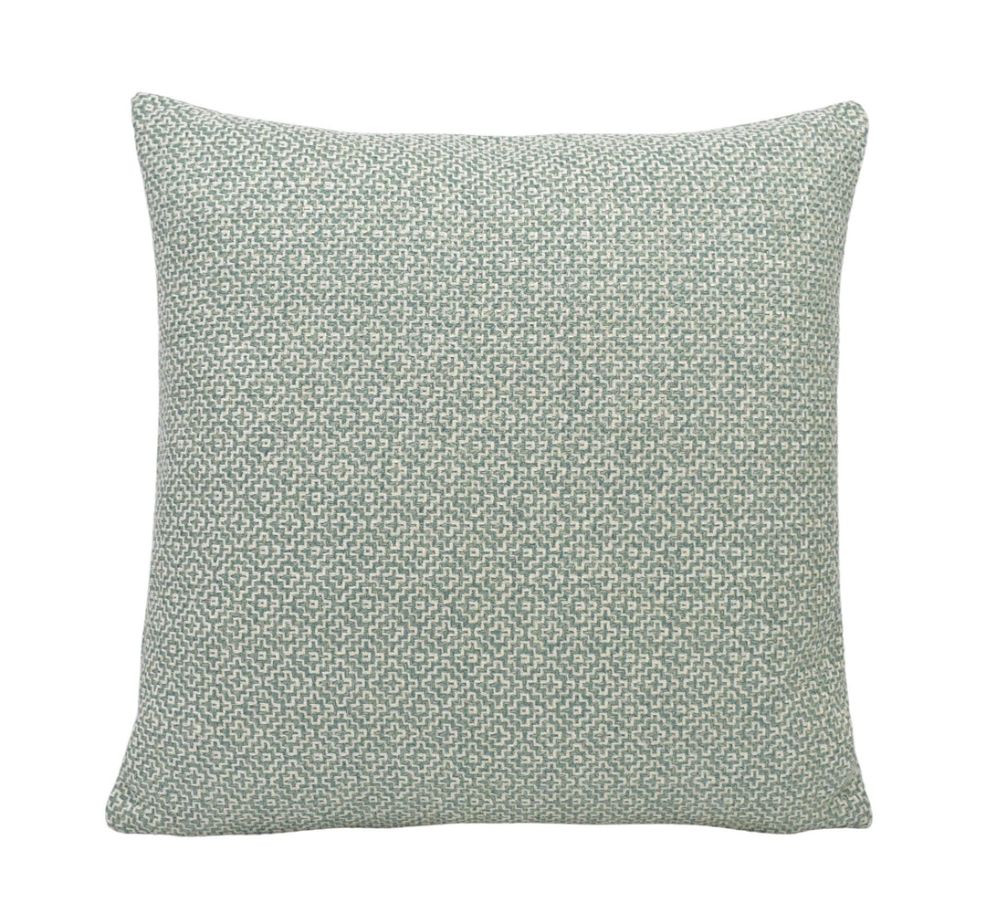 a green and white pillow on a white background