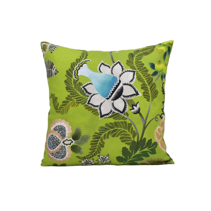 a green pillow with a blue flower on it