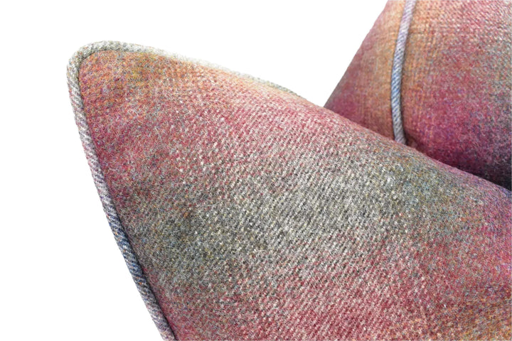 A close-up view of a textured fabric, possibly a pillow or cushion, with a multicolored pattern.