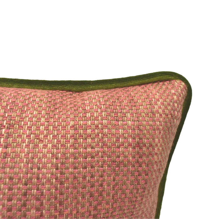 A close-up view of a red and green woven pillow against a white background.