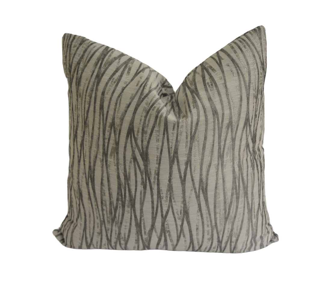 a gray and black pillow with a zebra print