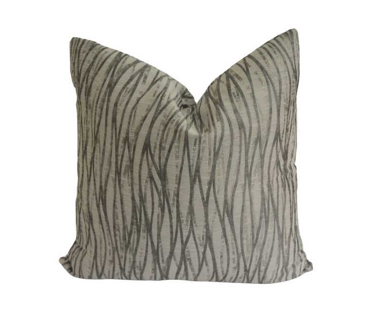 a gray and black pillow with a zebra print