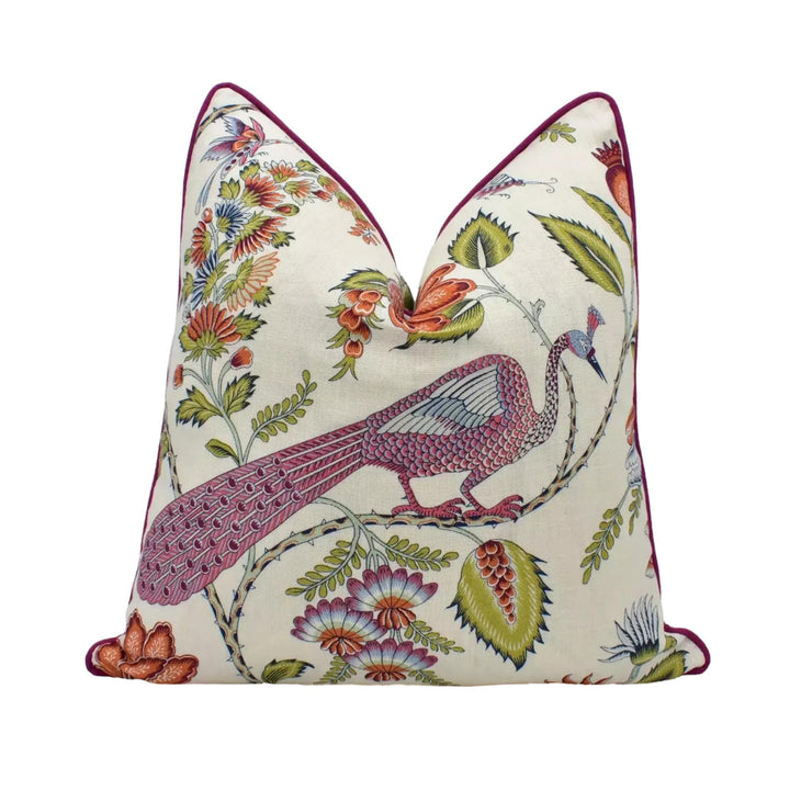 A decorative pillow with a vibrant floral pattern featuring a peacock, flowers, and leaves in various colors.