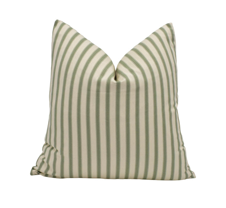 a green and white striped pillow on a white background