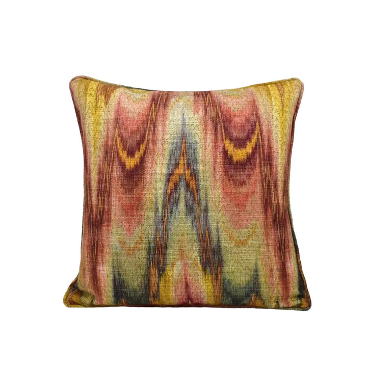 a vibrant, colorful pillow with an abstract, swirling pattern in shades of red, yellow, and green.