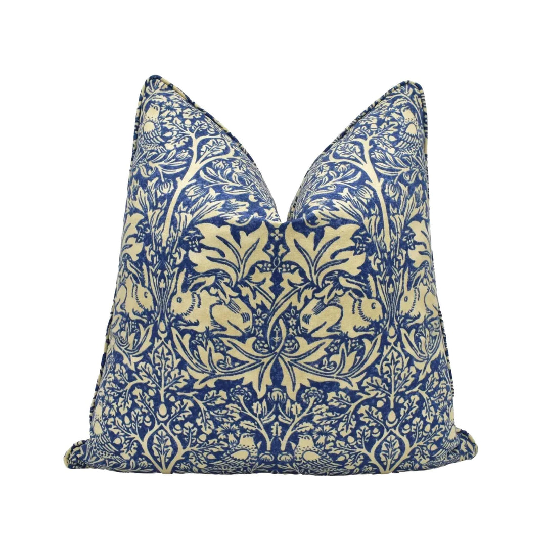 A decorative pillow with a blue and white floral pattern.