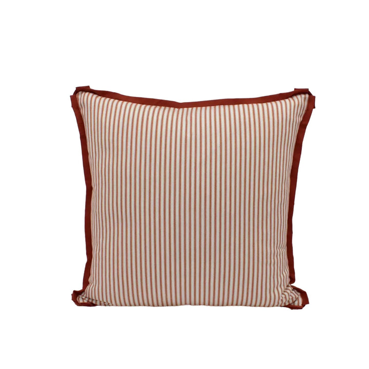 A square throw pillow with a striped pattern in shades of red and white.