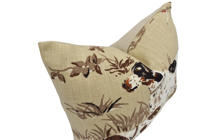 a brown and white pillow with a dog on it