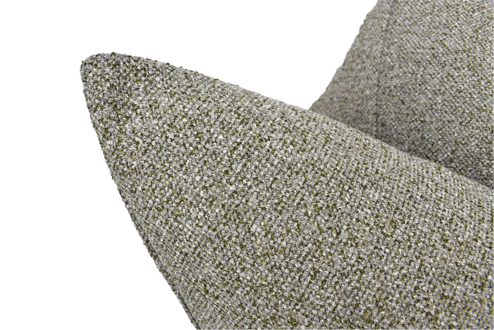 A close-up view of a textured, gray and green fabric, possibly a throw pillow or cushion, with a pointed, triangular shape.