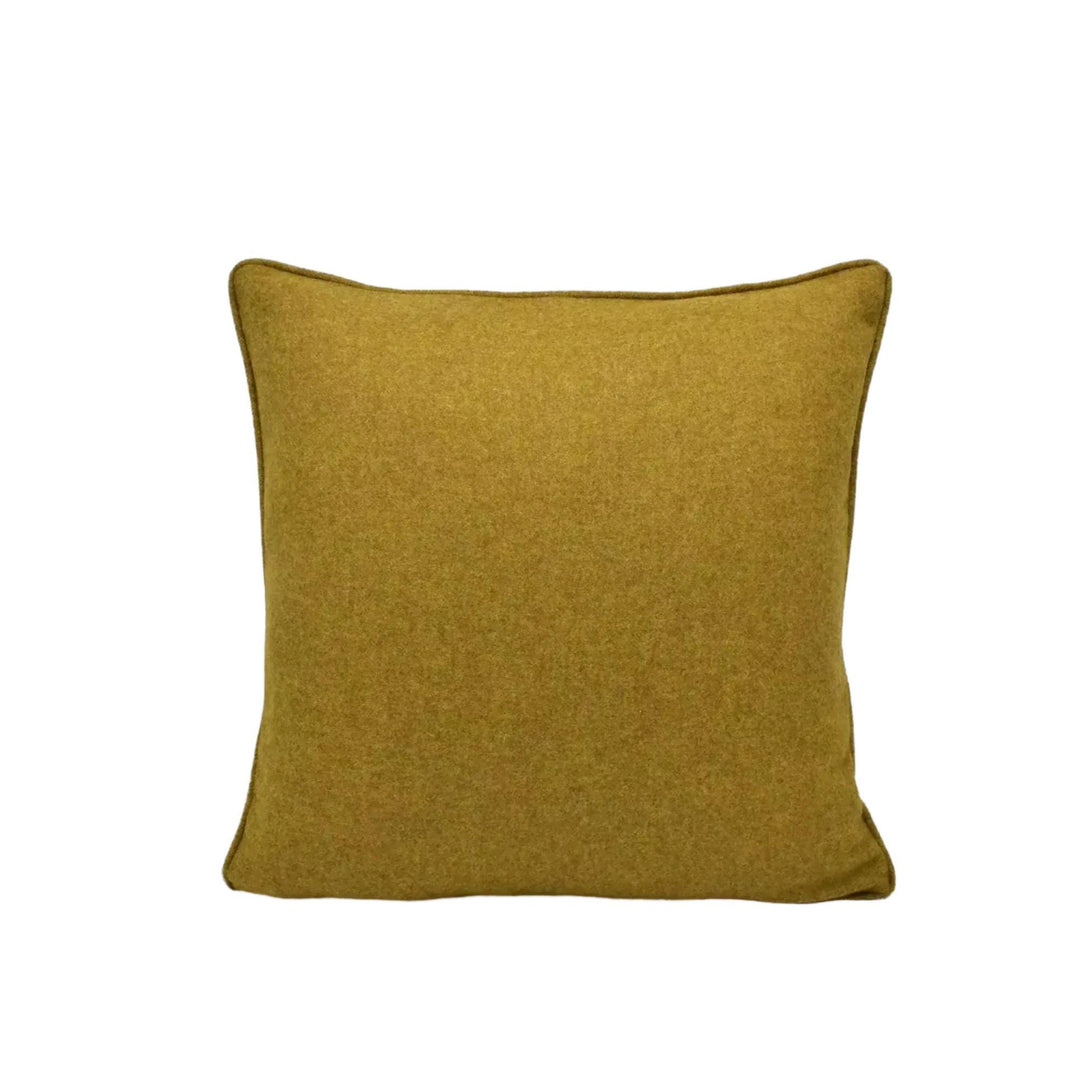 A single, square throw pillow with a solid, mustard-colored fabric.