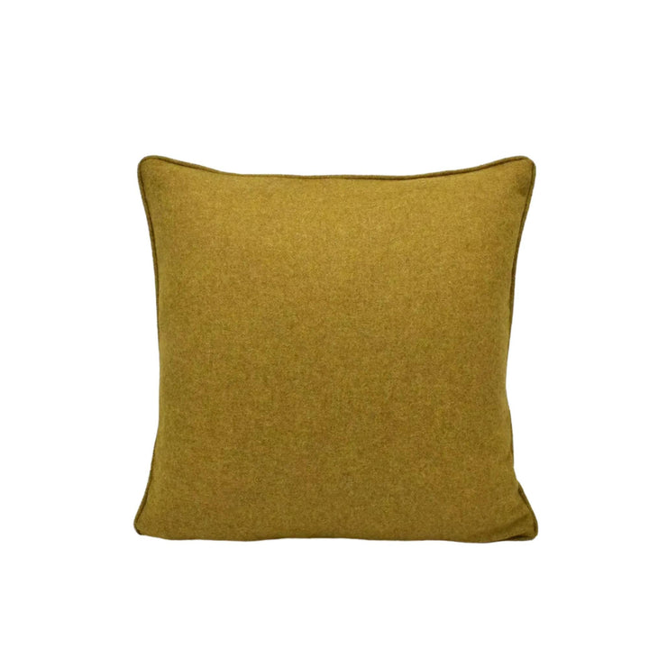 A single, square throw pillow with a solid, mustard-colored fabric.