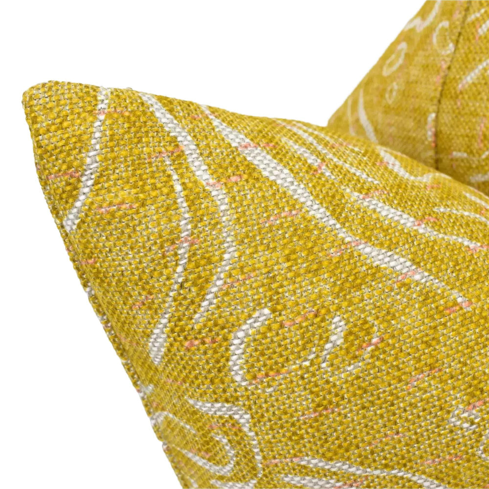 a close-up view of a yellow and white patterned fabric, possibly a pillow or cushion.