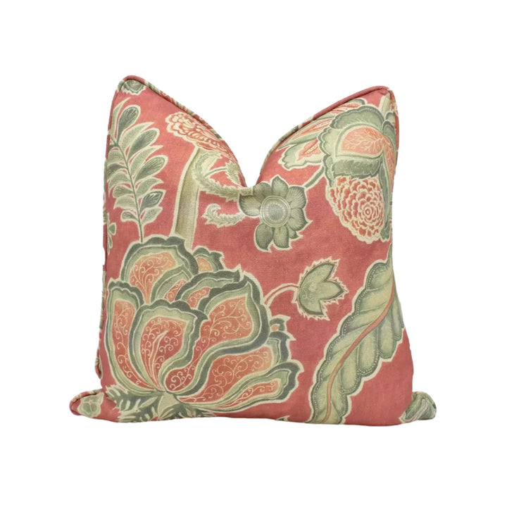 a decorative pillow with a floral pattern in shades of pink and green.