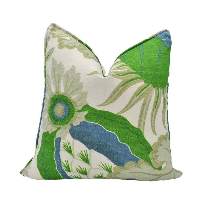 a decorative pillow with a floral pattern in shades of green and blue.