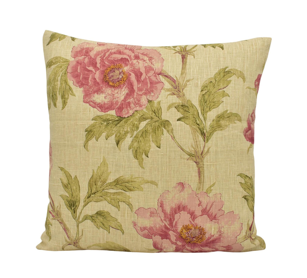 a pink and green flowered pillow on a white background