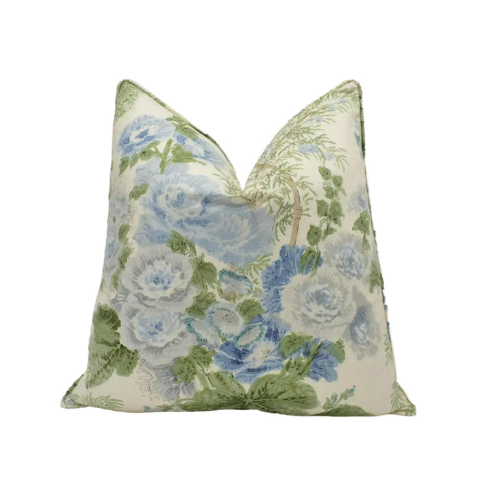 A decorative throw pillow with a floral print in shades of blue and green.
