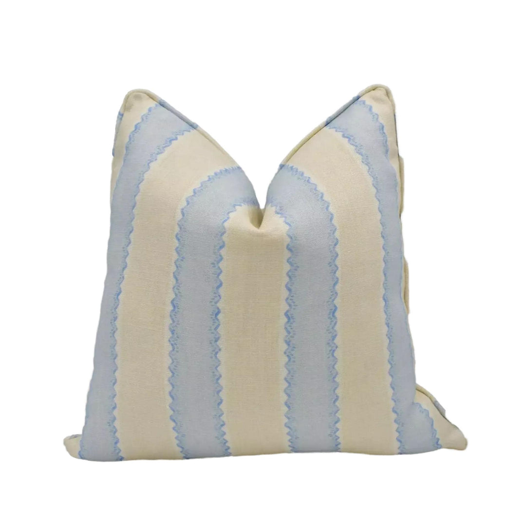 A pillow with a striped pattern in shades of blue and beige.
